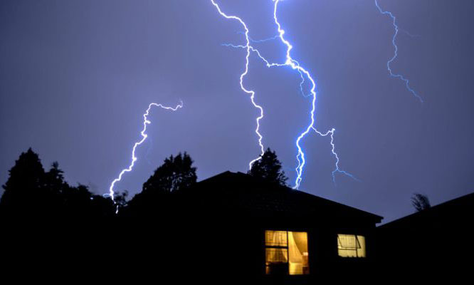 Lightning strike over a house at night | Dawson Electric