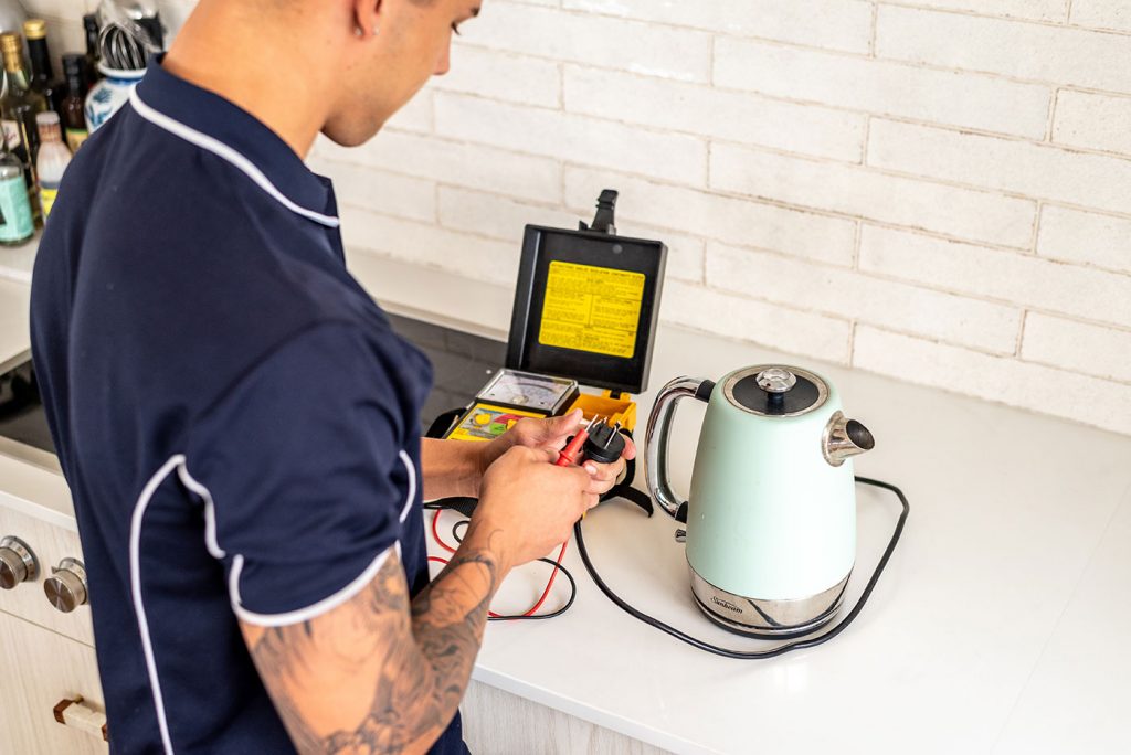 An electrician testing the power cable of an electric kettle | Dawson Electric