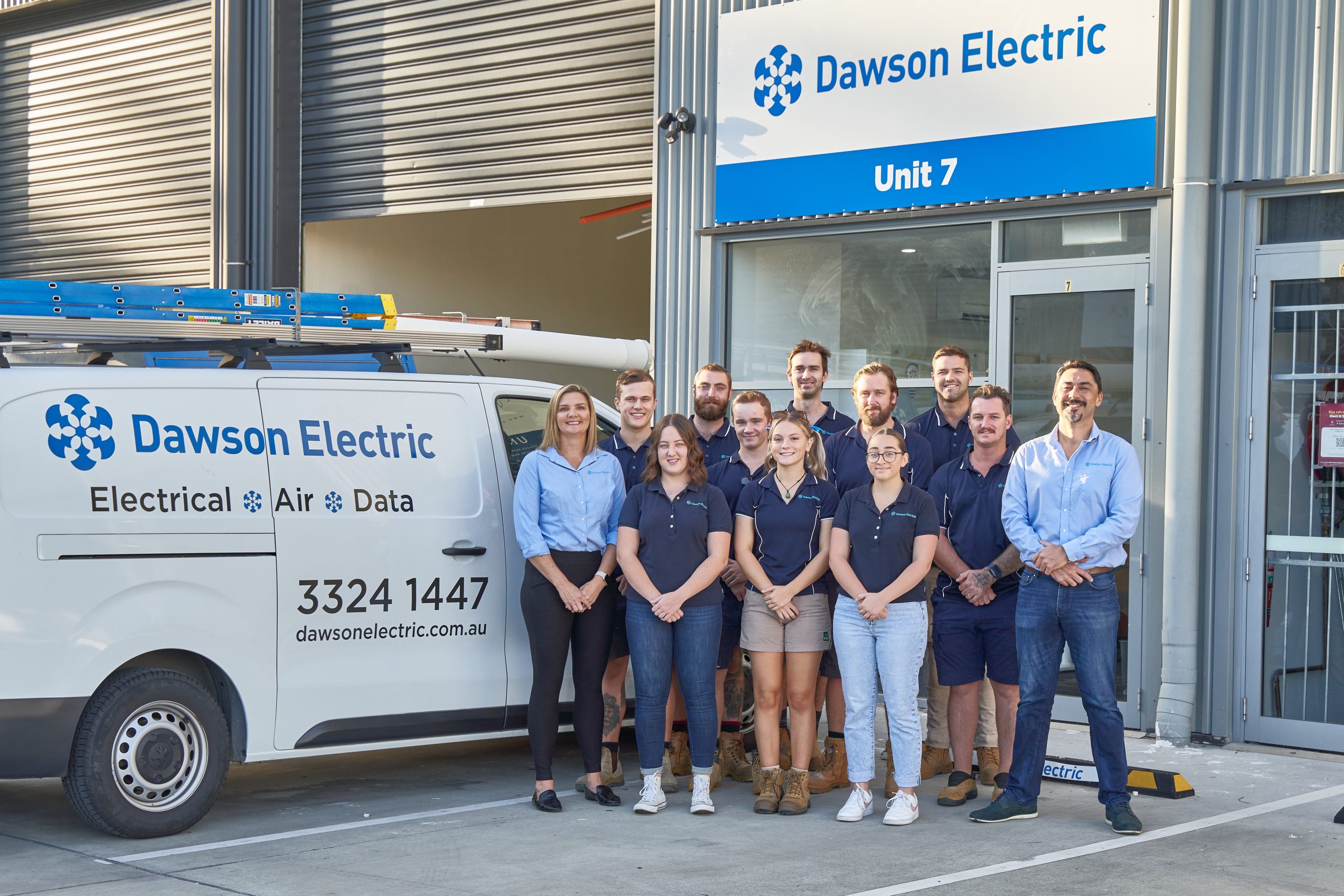 Electricians standing in front of Dawson Electric Van
